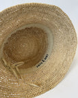 Inside of a straw bucket hat with adjustable strap