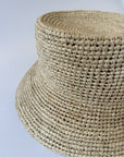 Close-up of a woven straw hat on a light gray background