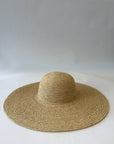 Beige straw floppy hat on a white background