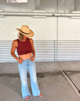 Person wearing the Raffie Straw Western Hat with black leather band