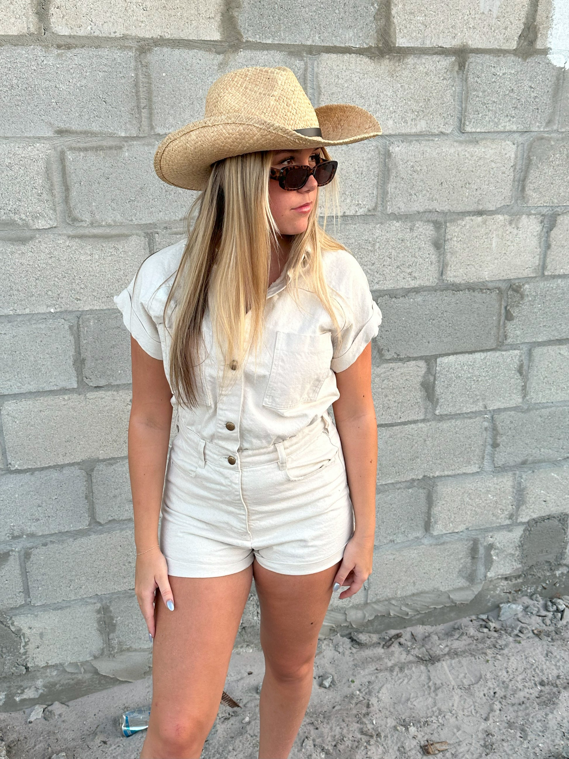 Person wearing the Raffie Straw Western Hat with black leather band
