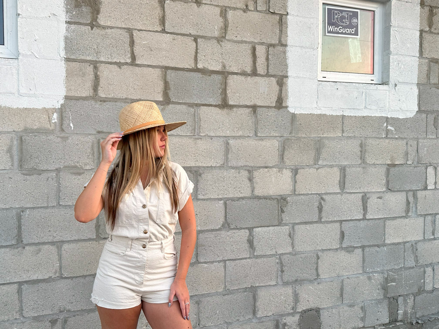 Person wearing straw panama hat with a tan leather band.