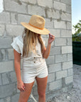 Person wearing straw panama hat with a tan leather band.