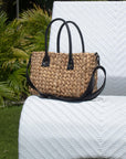 Medium sized hyancinth straw bag with black leather handles and black crossbody strap