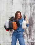 Person holding the collection of Orlando Crossbody Belt bags in 9 colors.