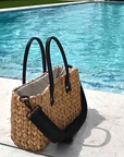 Medium sized hyancinth straw bag with black leather handles and black crossbody strap