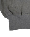 Close-up of a gray knit jacket with a & logo on a white background