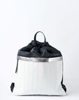 Black & white nylon cinch top backpack with signature leather and shiny silver details.
