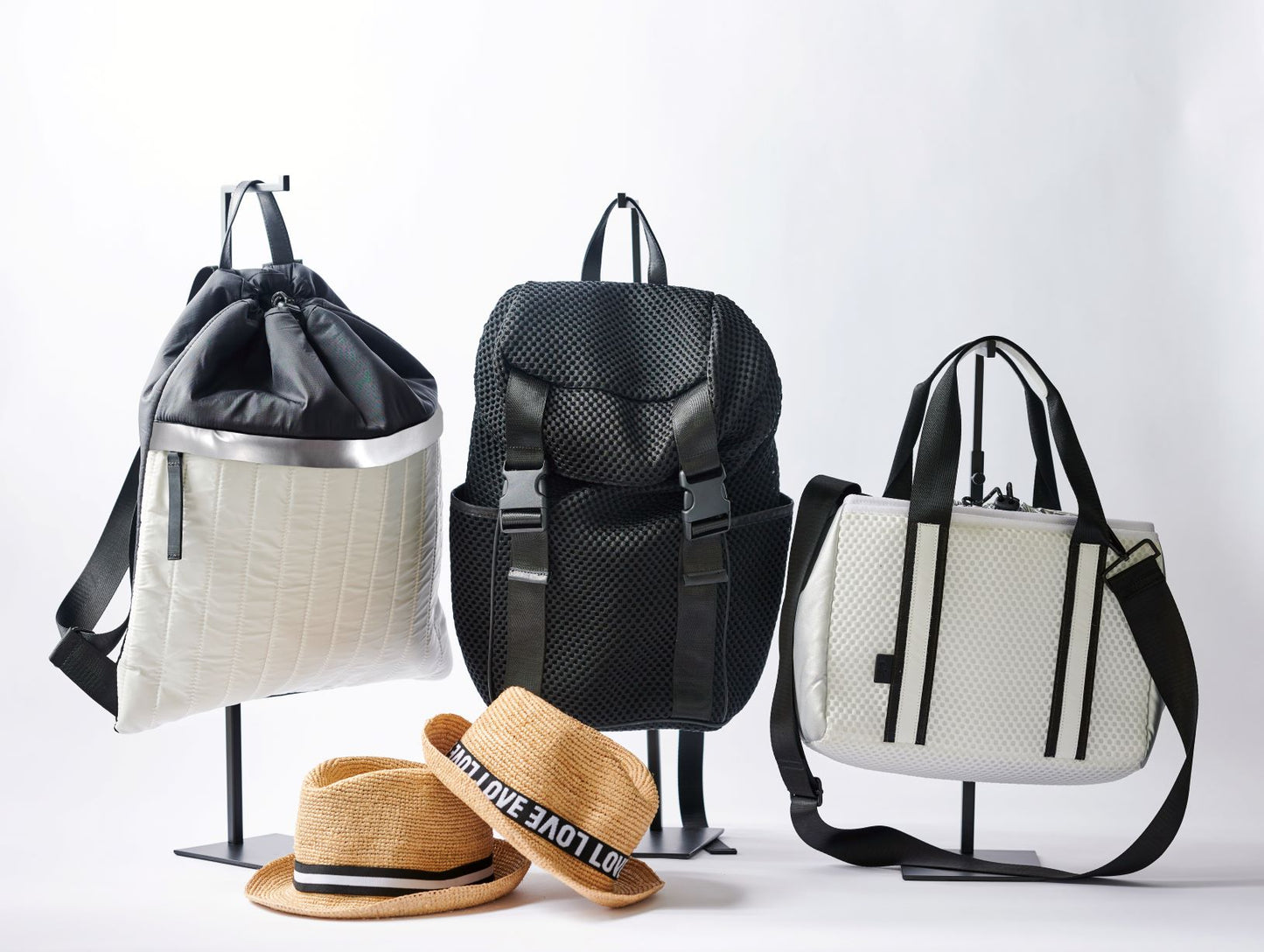 Collection of Anya & Niki active nylon and mesh bags and straw hats.