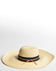 Natural floppy straw hat with black grosgrain ribbon and thin brown leather band.