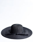 Black floppy straw hat with multi-strand black cording band.