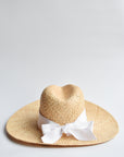 Natural raffia straw panama hat with white grosgrain tie.