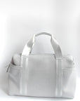 Callahan light gray perforated neoprene duffel bag with grey straps and leather details.