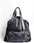 Black nylon convertible backpack tote with leather details.