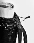 Close up of glossy black yoga mat bag top cinch closure.