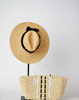 Everywhere straw hat with black grosgrain band and small straw tote bag with leather handles.
