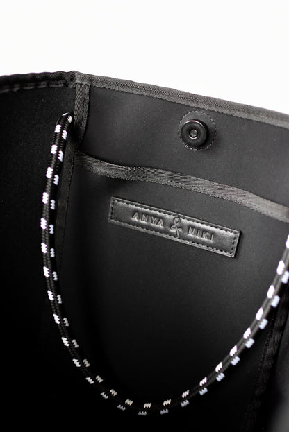 Close up of interior pocket on gray perforated neoprene tote bag.