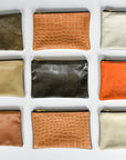 Collection of small limited edition leather and denim pouches from Anya & Niki.