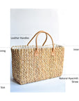 Extra large natural hyacinth straw tote with matching leather handles.