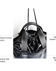 Black neoprene tote bag with high shine cinch top closure and leather details