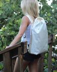 Person wearing off-white faux croc embossed Casselberry backpack