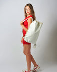 Person wearing off-white faux croc embossed Casselberry backpack