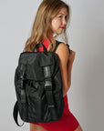 Person wearing the Delray black nylon backpack with mesh back and leather details.
