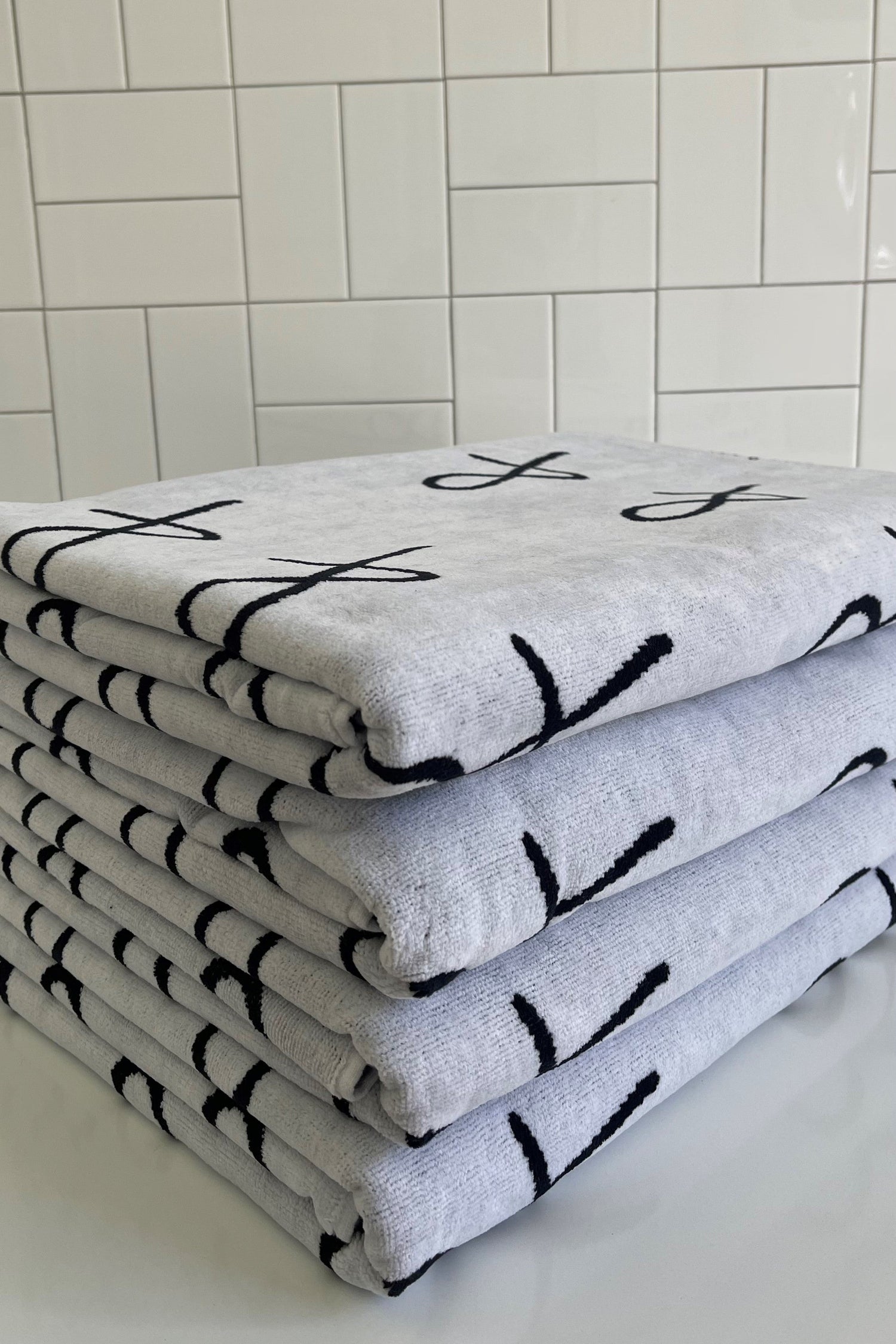 stack of A&N logo beach towels