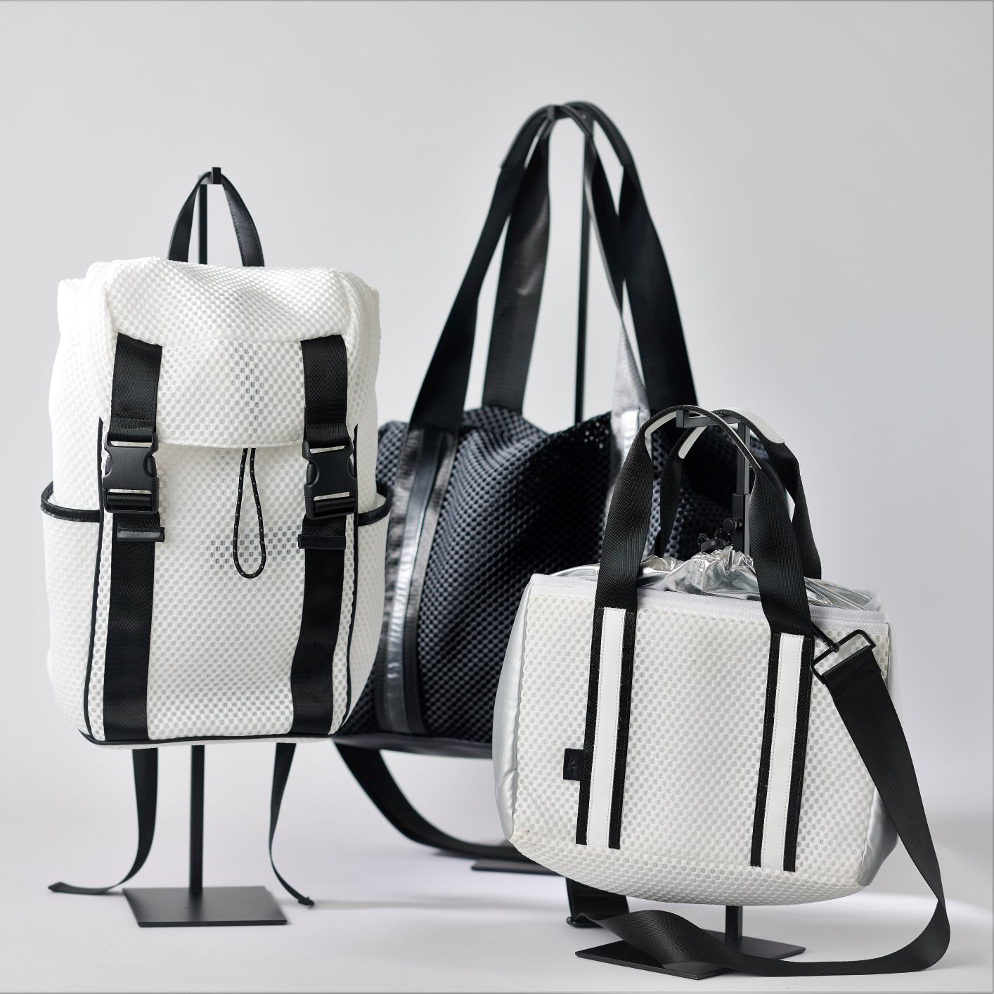 Collection of 3 Mesh Luxe Sport Bags: white newberry backpack, black stanton duffel and white midway small crossbody
