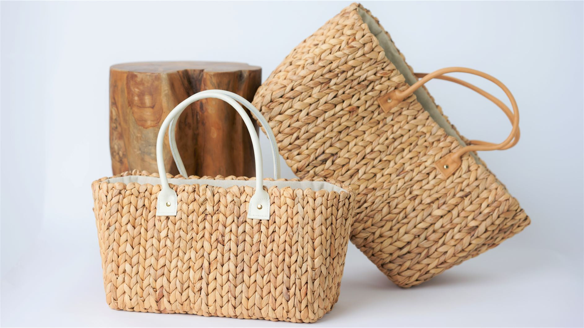 Collection of hyacinth straw bags with leather handles in medium and large sizes