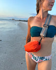 Person at the beach wearing the Orlando Orange with Grey Strap