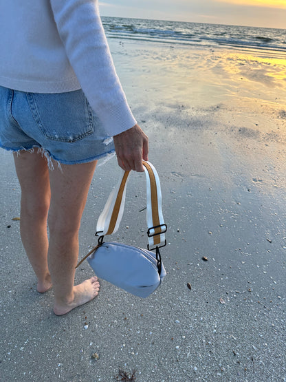 Person on the beach holding the Orlando Gray Nylon Belt Bag
