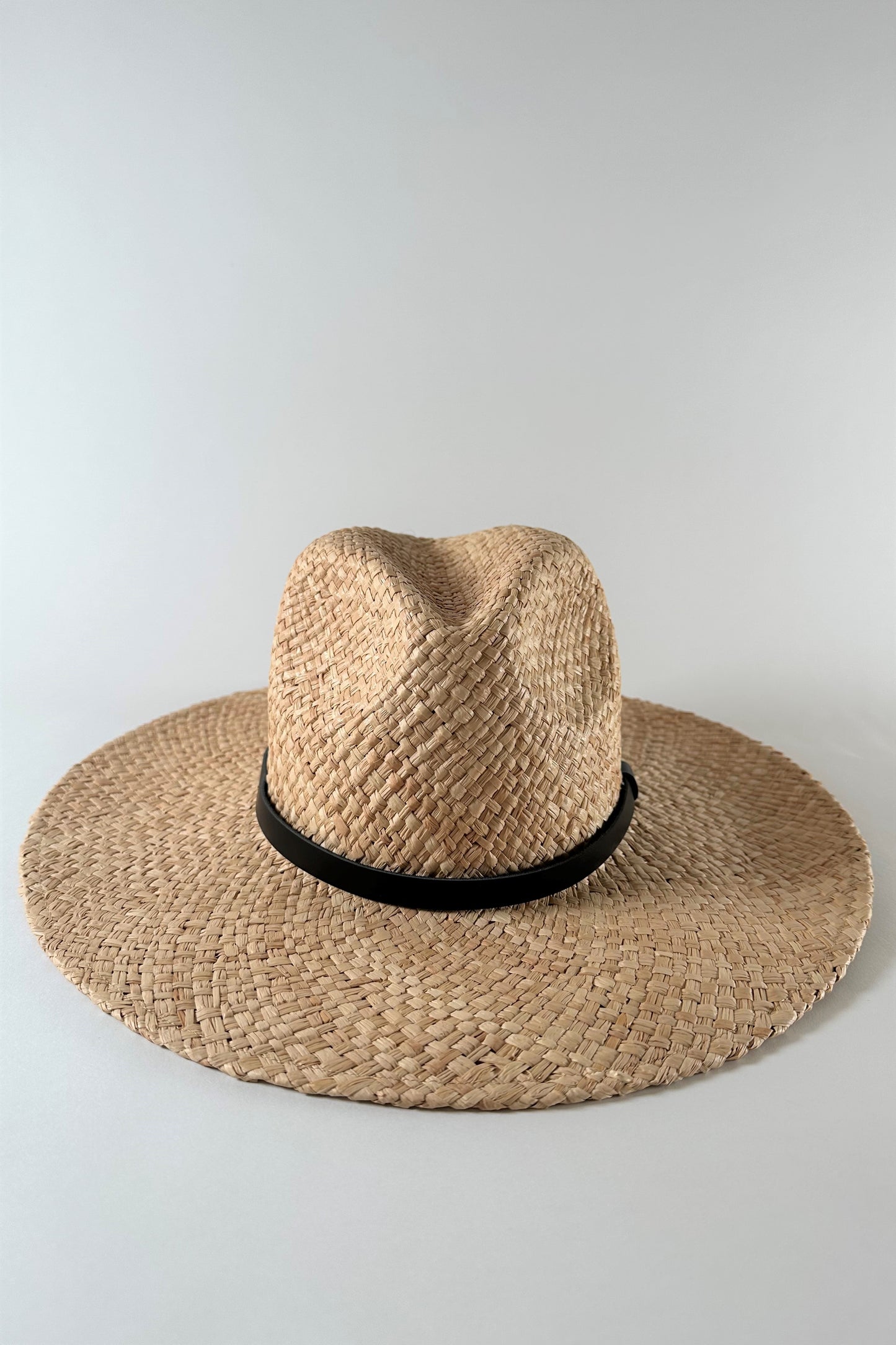 Straw panama hat with a black leather ba