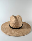 Straw panama hat with a black leather ba