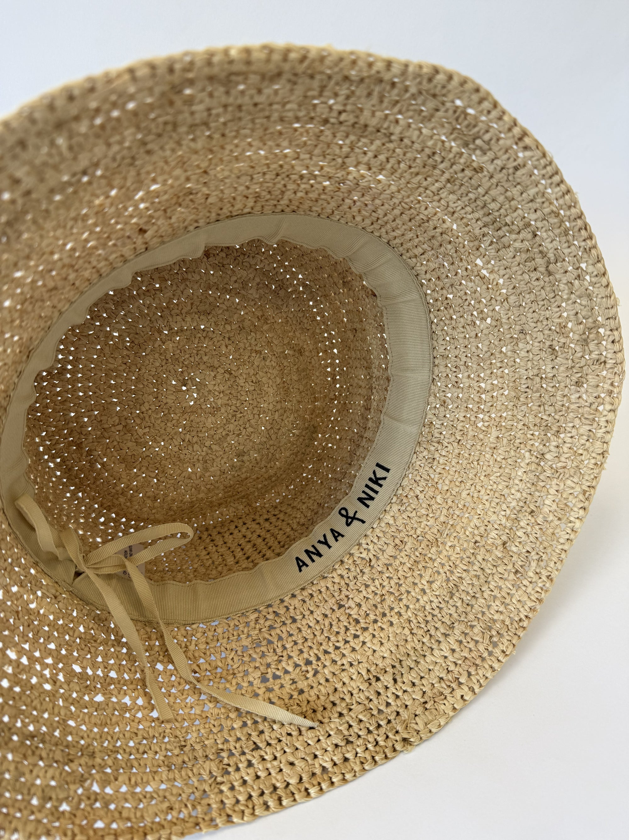 Inside of a straw bucket hat with adjustable strap