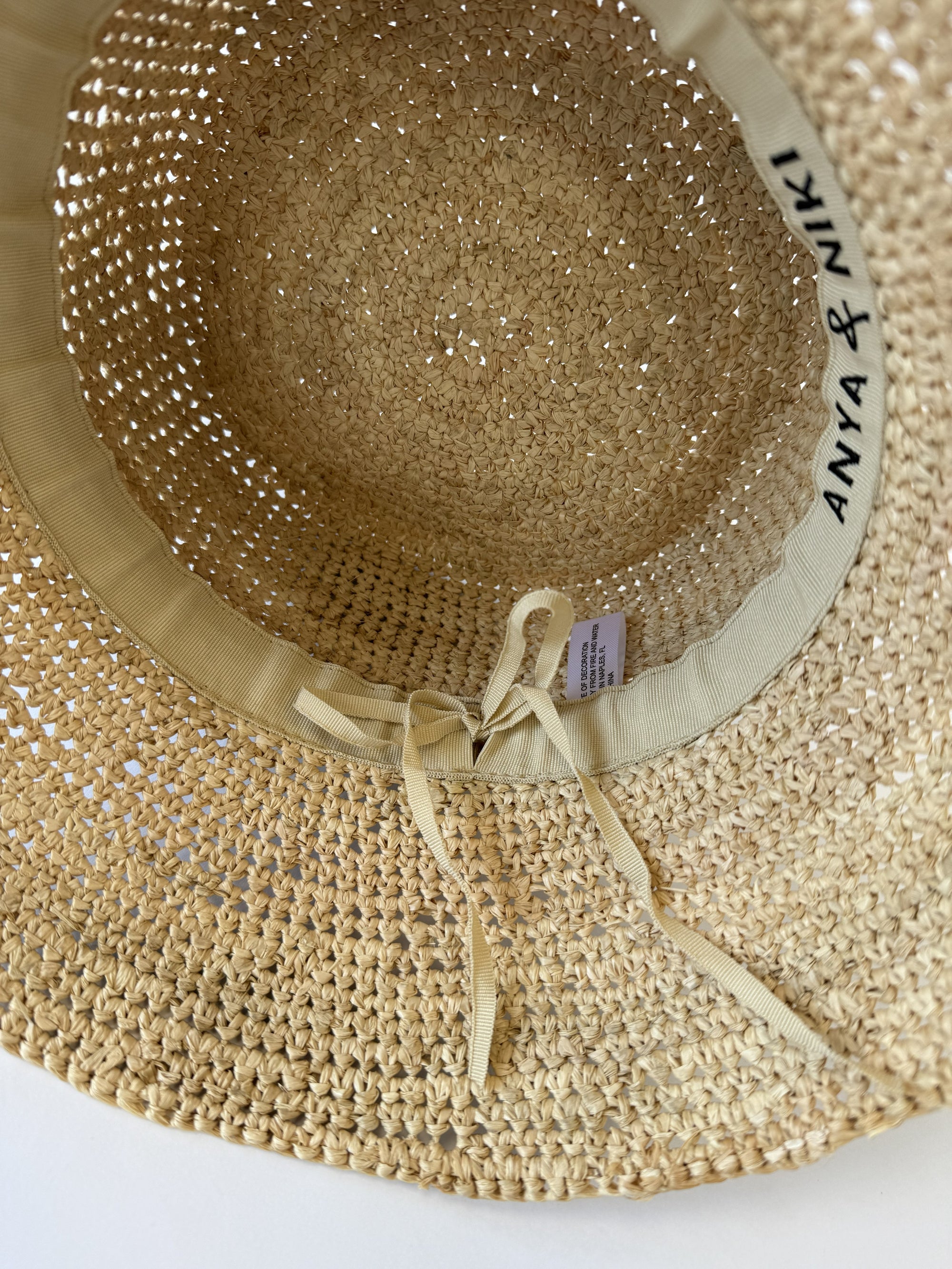 Beige straw hat with a ribbon and 'Anya &amp; Niki' branding on a white background