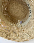 Beige straw hat with a ribbon and 'Anya & Niki' branding on a white background