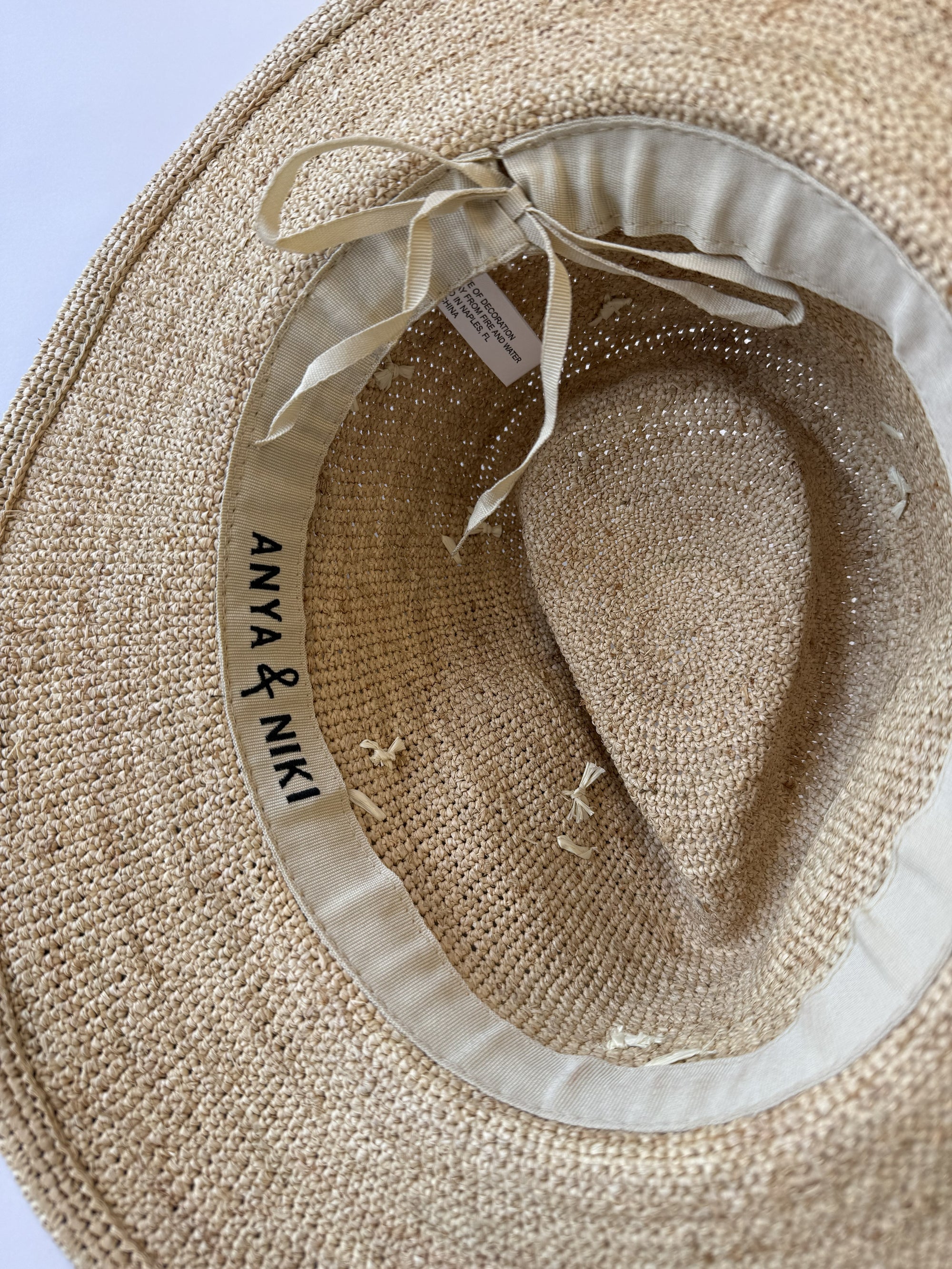 Close up of inside of straw hat with adjustable band