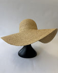 Beige straw floppy hat on a mannequin