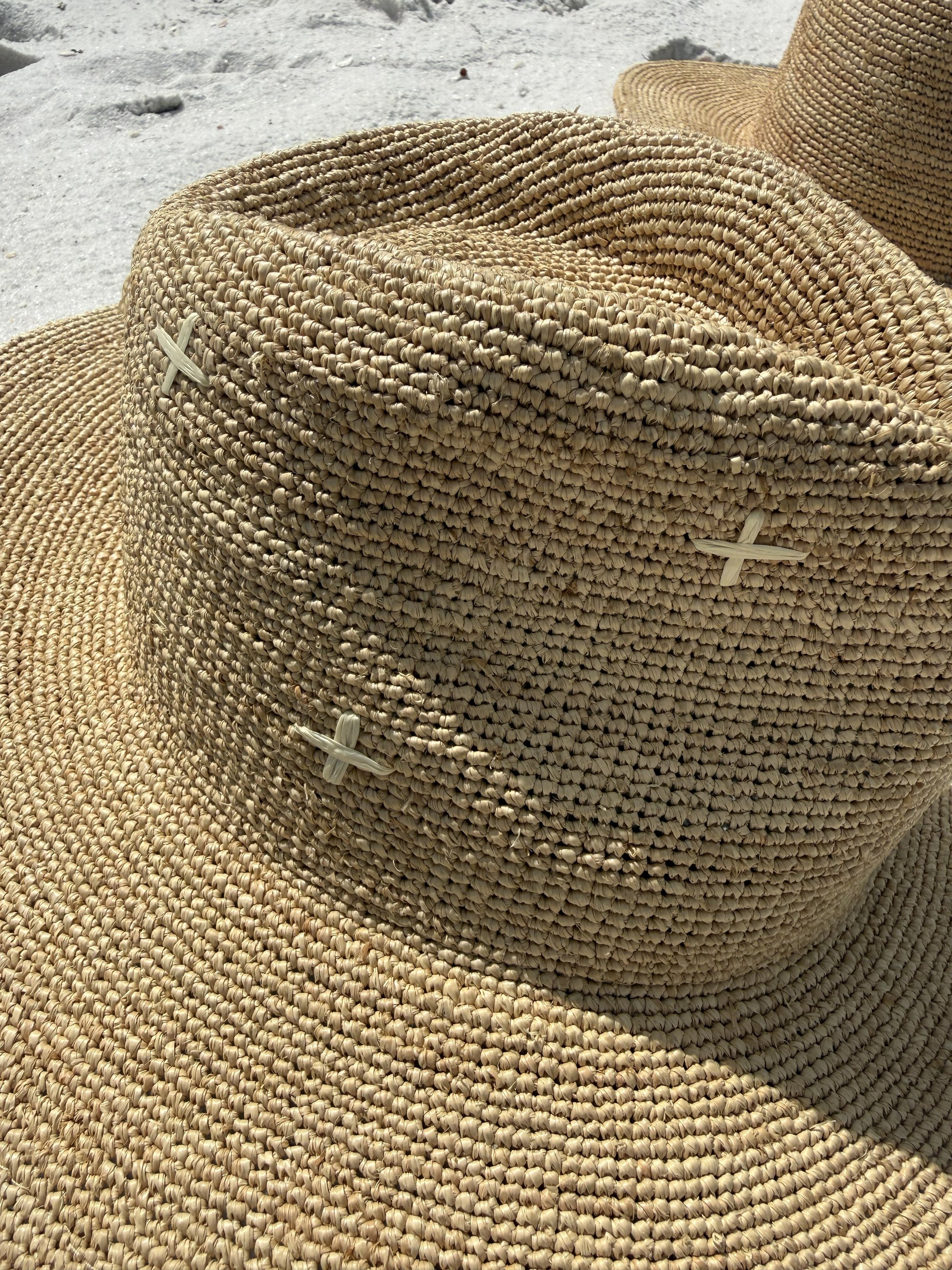 Close-up of a woven straw hat with visible stitching details.