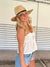 Person wearing straw panama hat with a black leather band