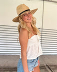 Person wearing straw panama hat with a black leather band