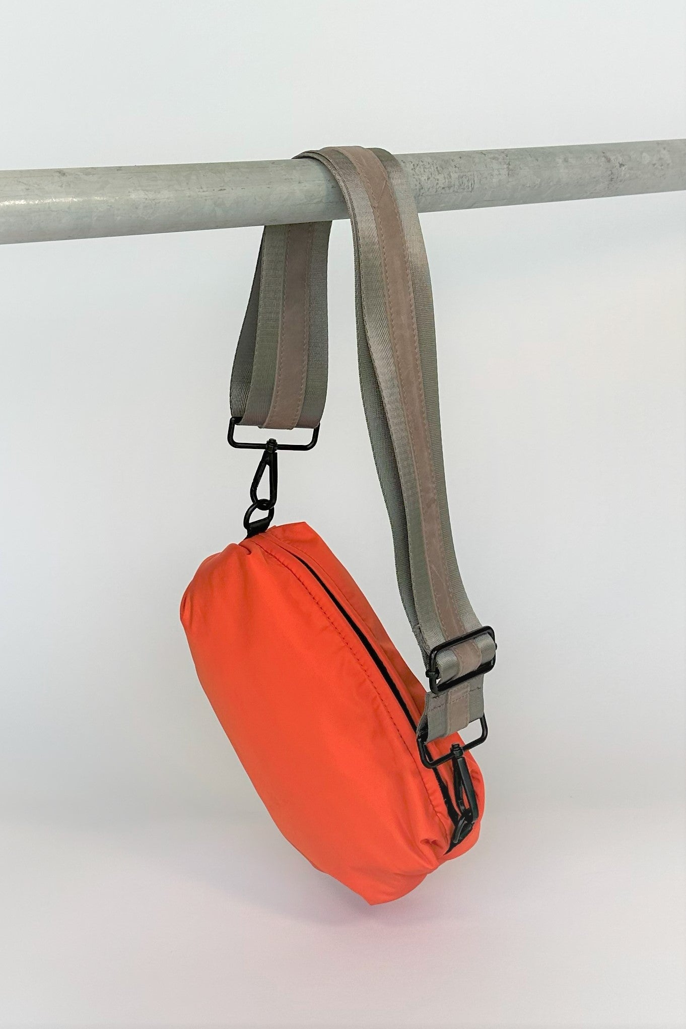 Orange nylon belt bag with grey crossbody strap and grey leather detail