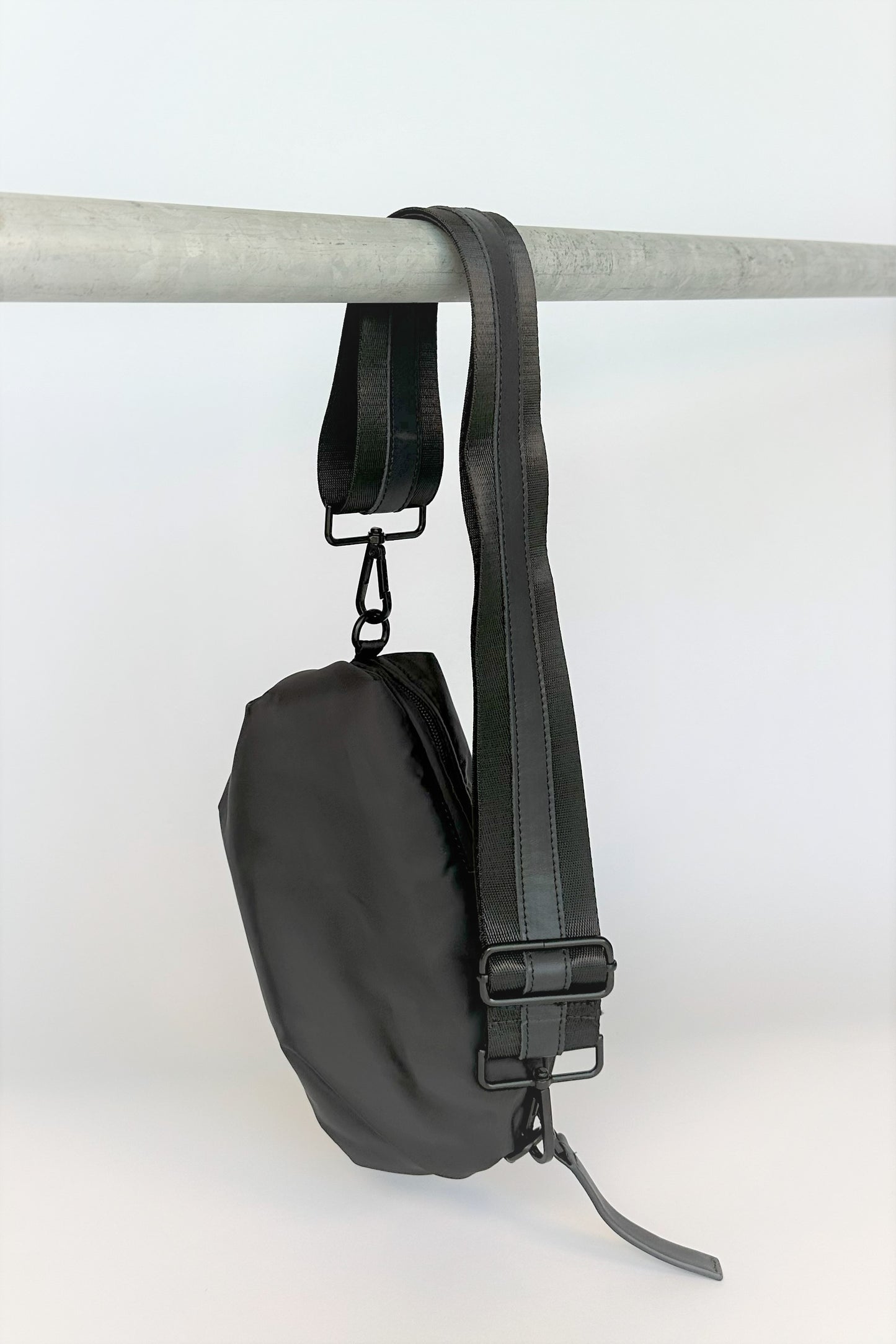 black nylon belt bag with black crossbody strap with black leather detail