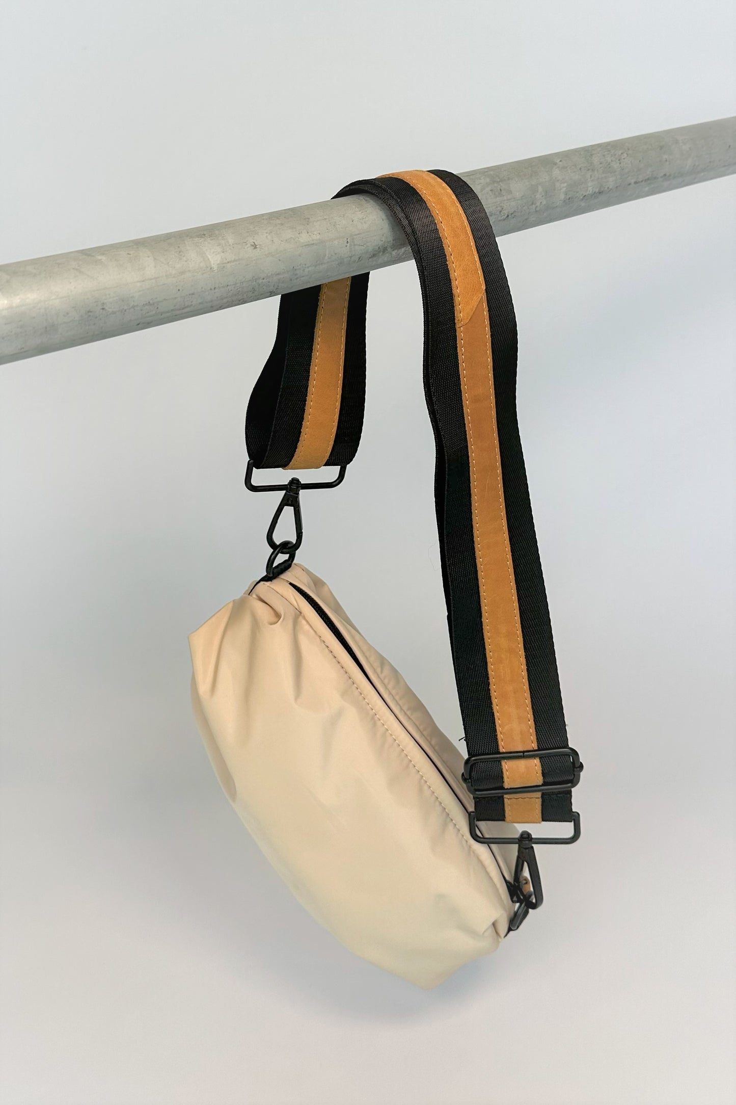 cream nylon belt bag with black crossbody strap with natural leather detail