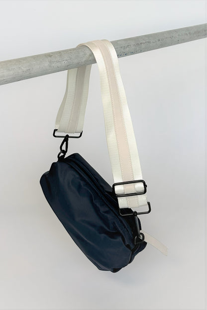 navy nylon belt bag with white crossbody strap with white leather detail