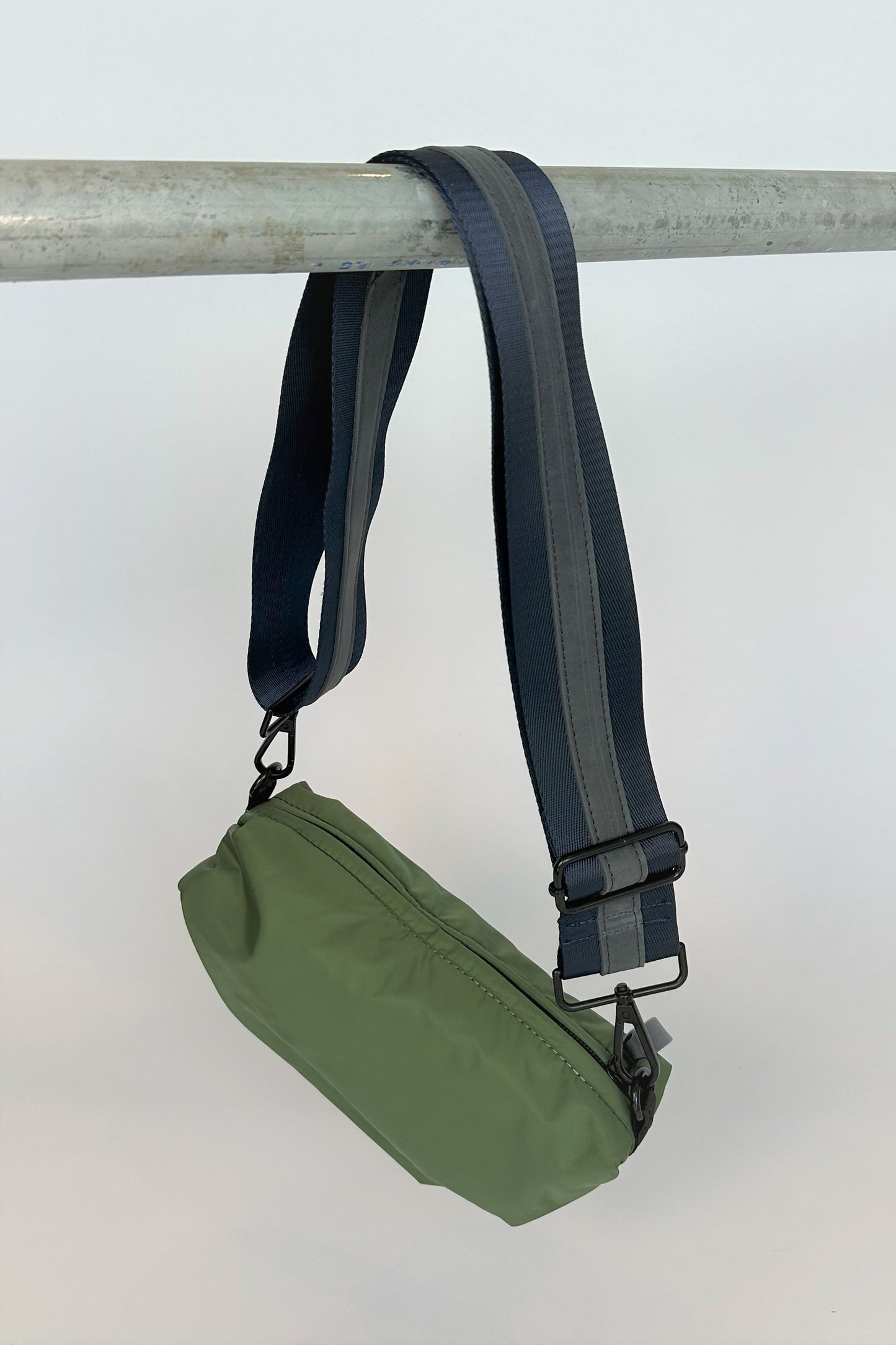 olive green nylon belt bag with navy crossbody strap