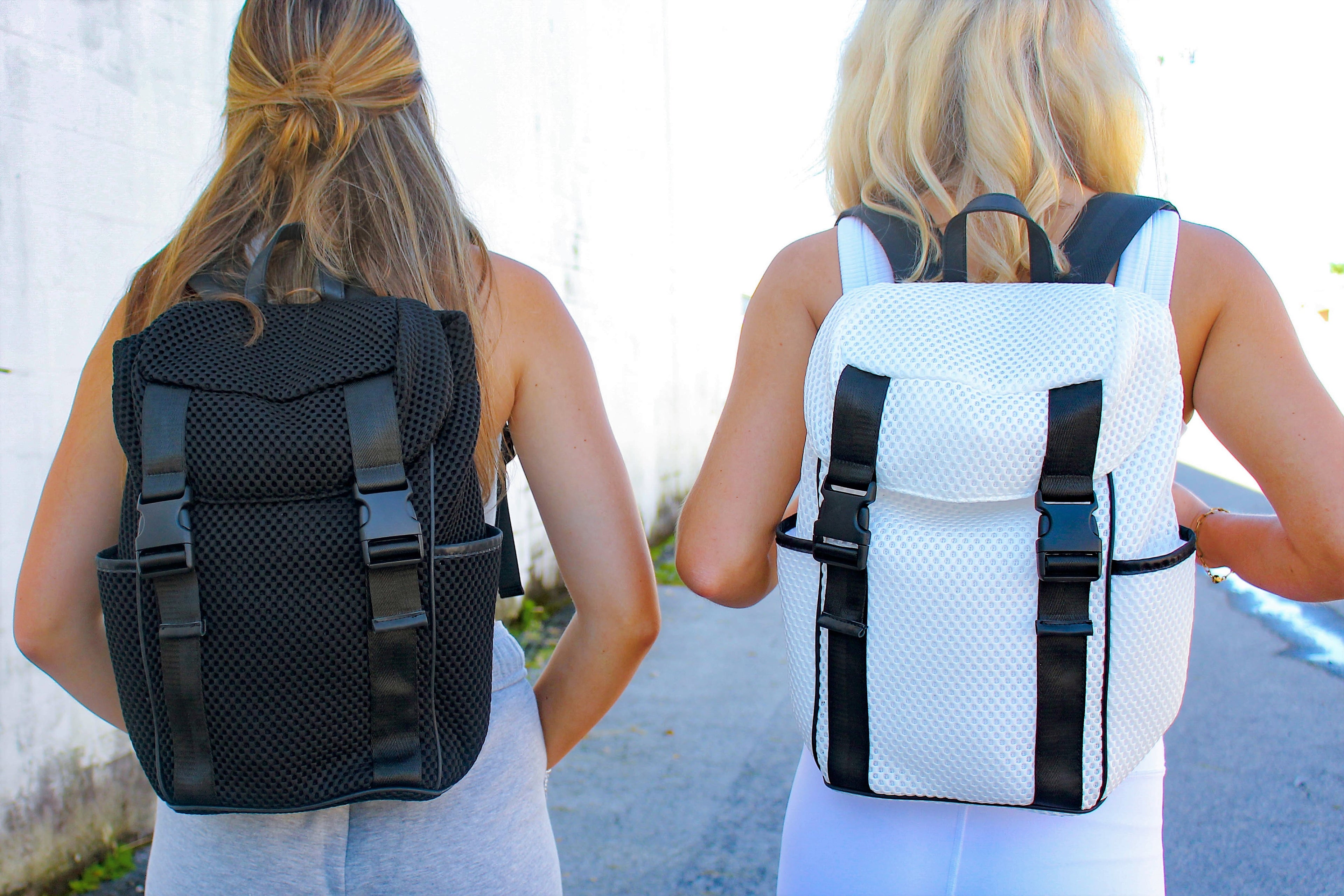 two girls wearing mesh backpacks