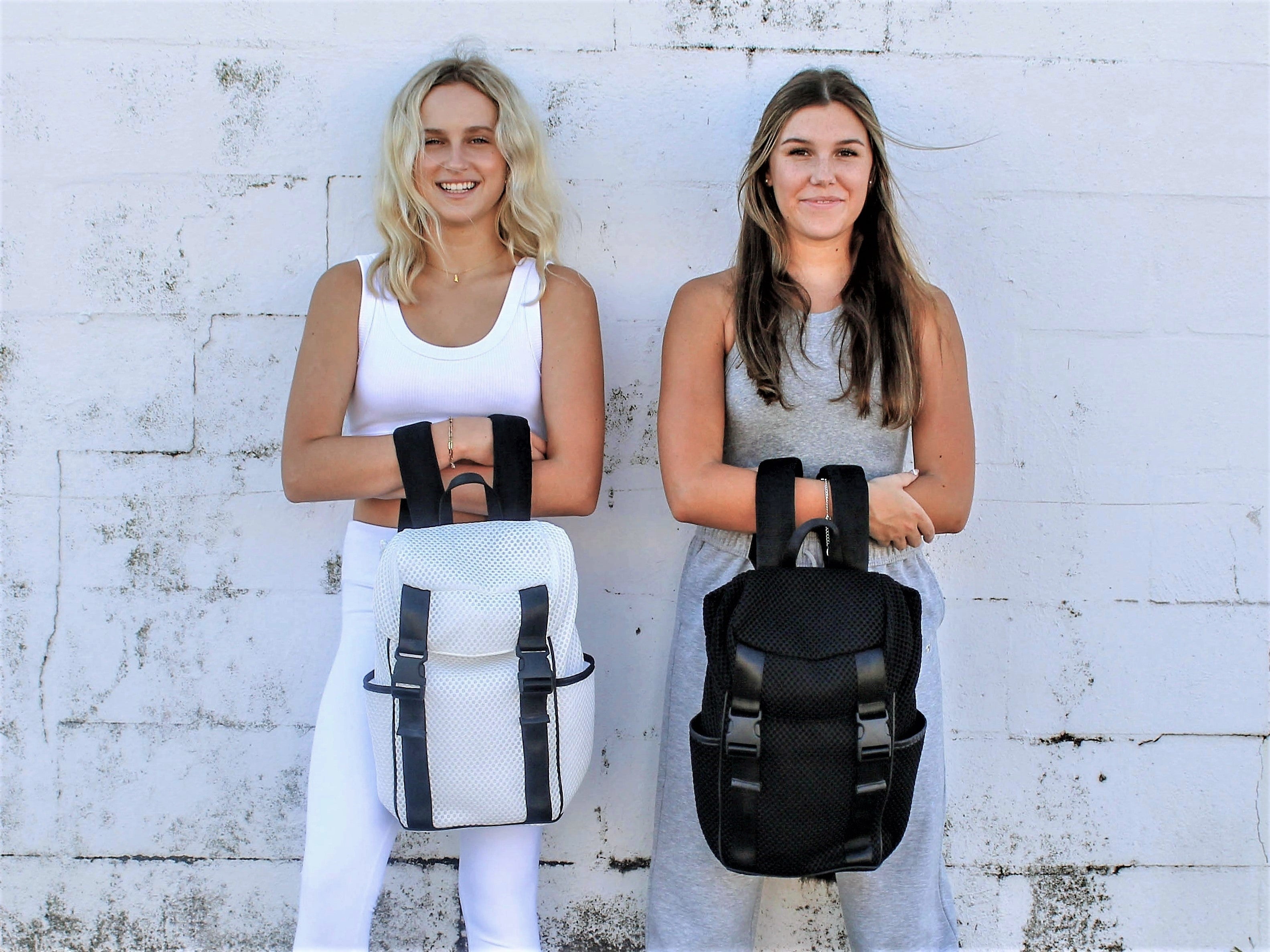 two people holding mesh backpacks