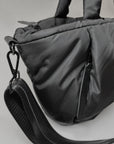 Mid-sized black nylon puffy tote with removable crossbody strap with leather detail